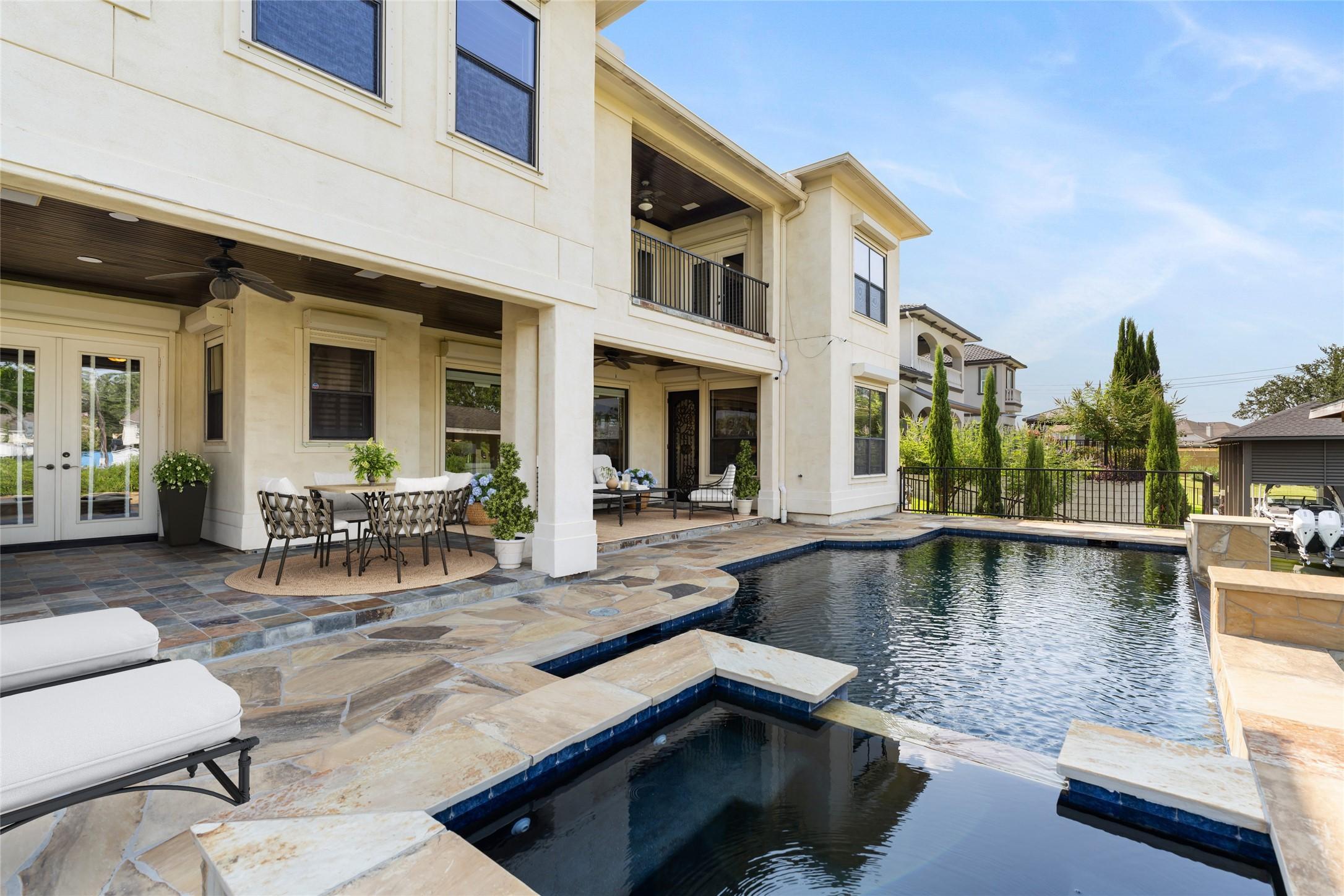 Image 4: The infinity edge swimming pool and spa provide am