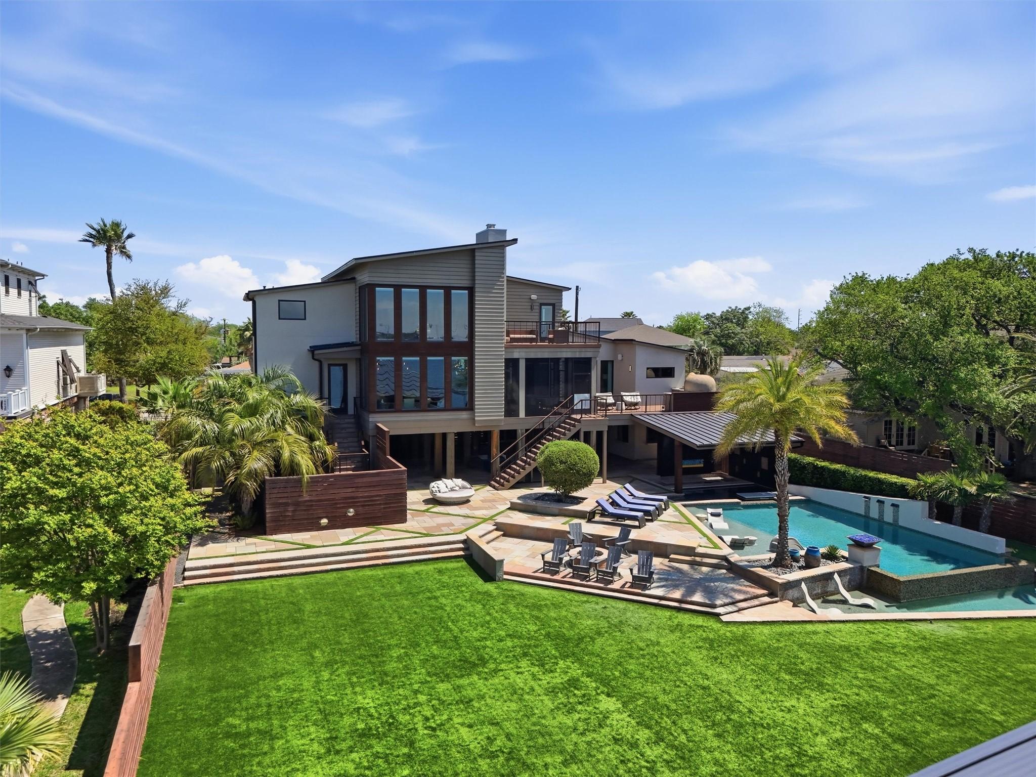 Image 1: A true backyard oasis designed for resort-style li