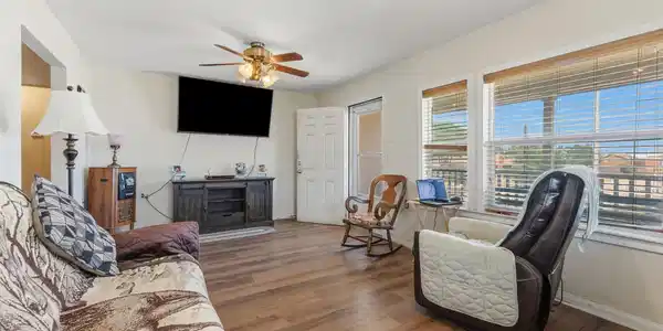 Image 2: Living room with view of front entrance.