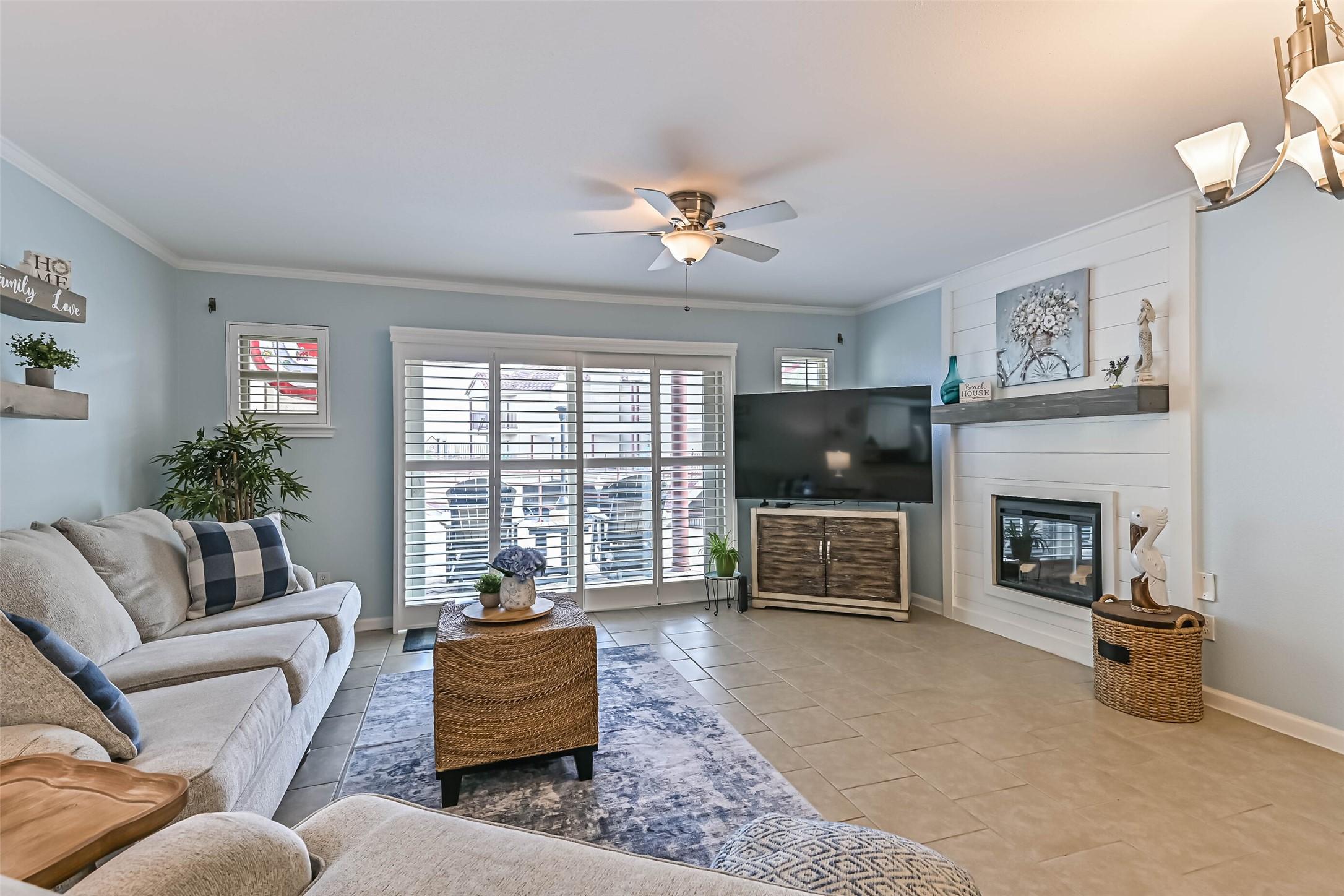 Image 2: Spacious living room with a cozy fireplace for tho