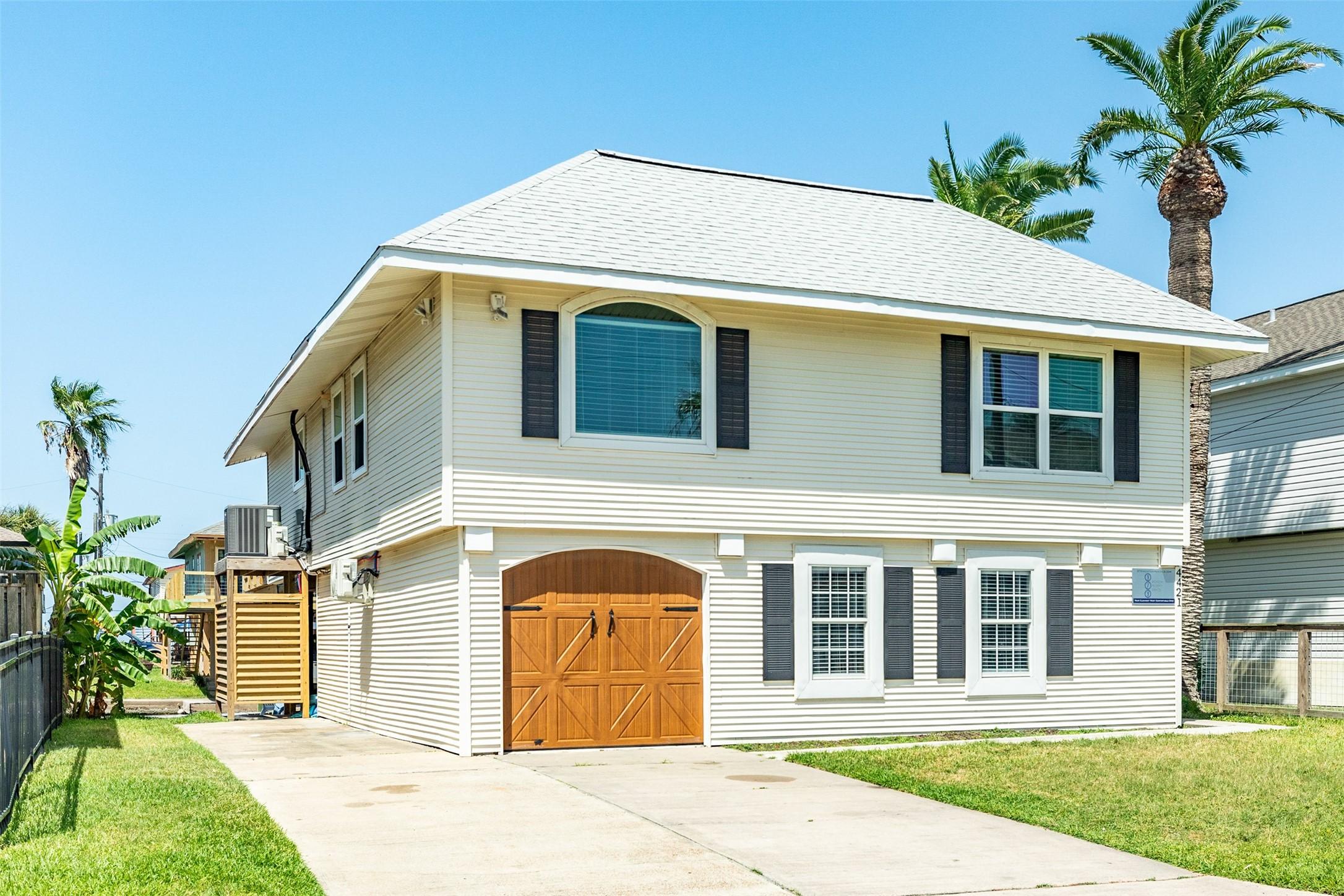 Image 2: Front of home with large double-wide driveway and