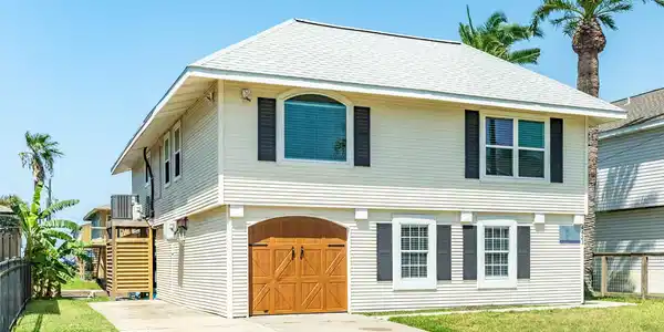 Image 2: Front of home with large double-wide driveway and