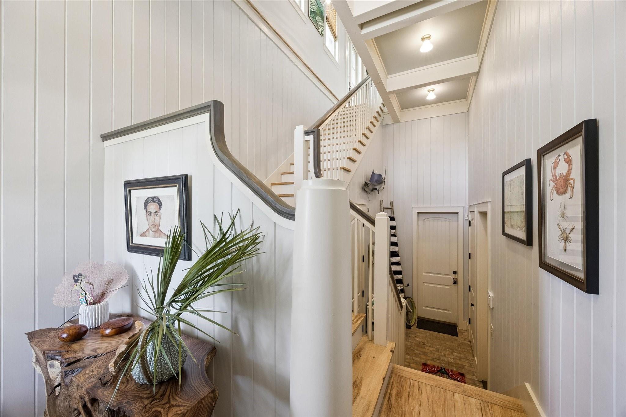 Image 3: Entry foyer.  Steps down to garage entry with elev