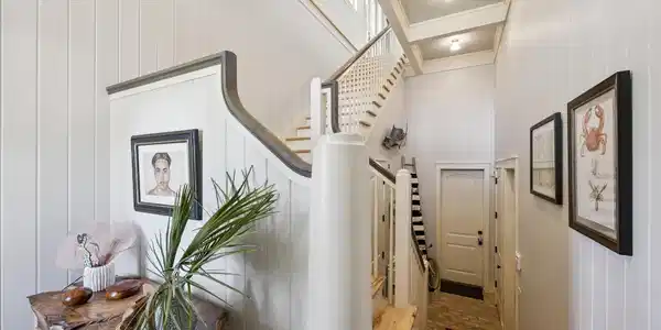 Image 3: Entry foyer.  Steps down to garage entry with elev