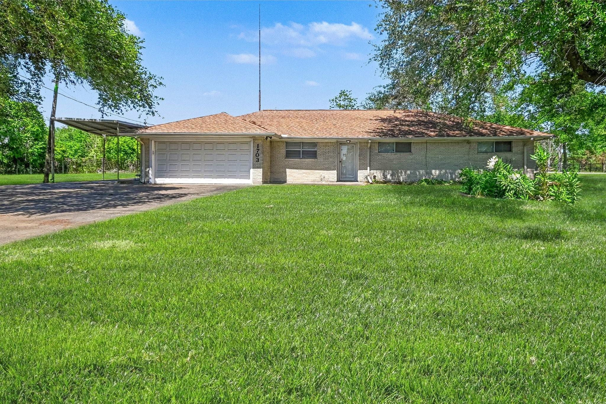 Image 2: This charming home offers ample space with a lush