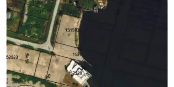 Image 4: The aerial photo shows a waterfront view with mult