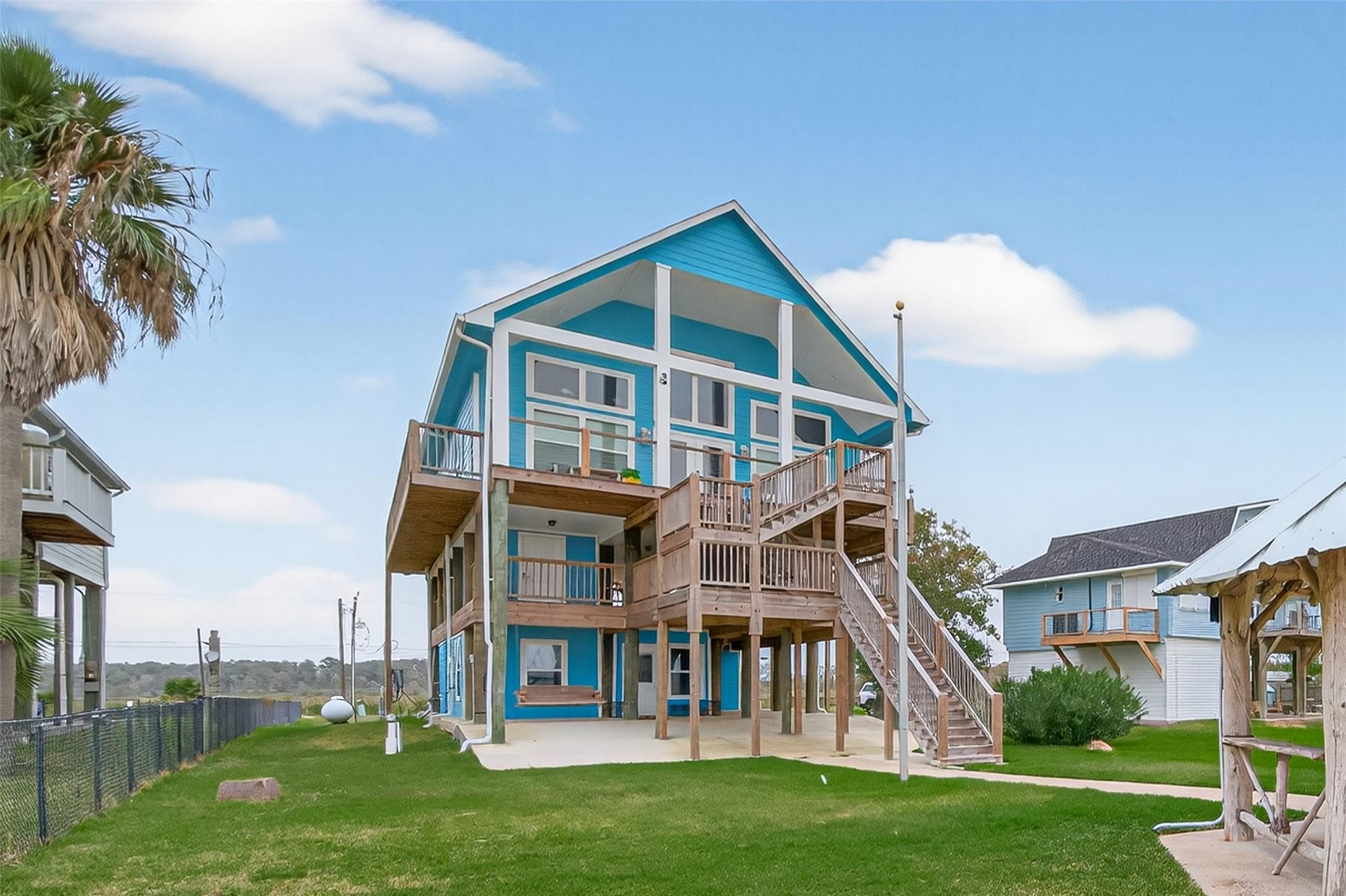 Image 1: This charming, elevated beach house features a vib