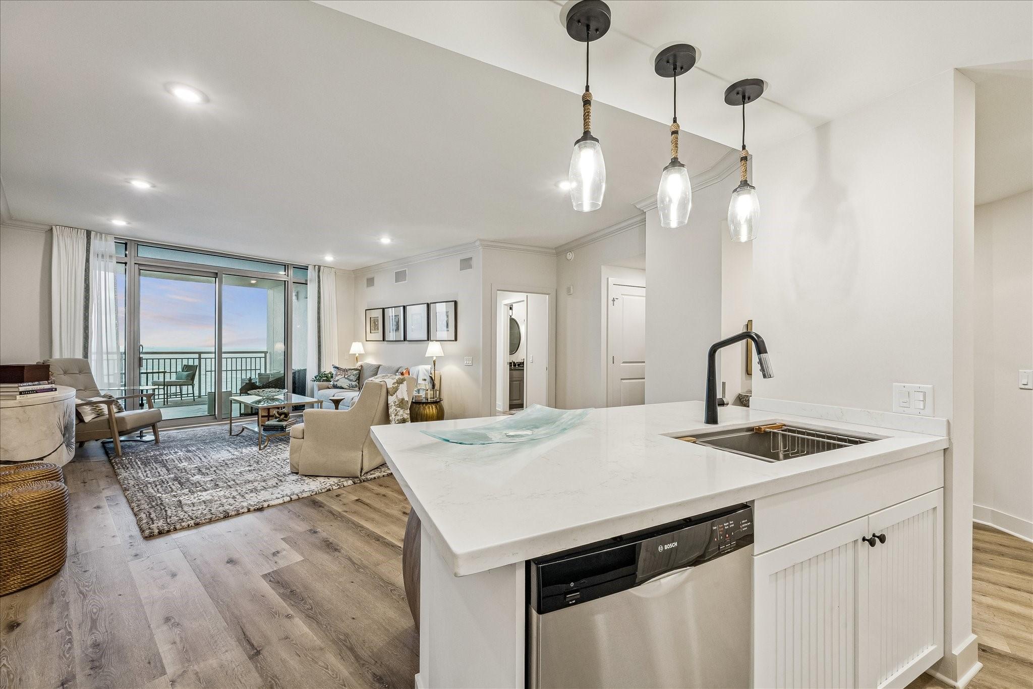 Image 3: This modern open-concept living space features a s