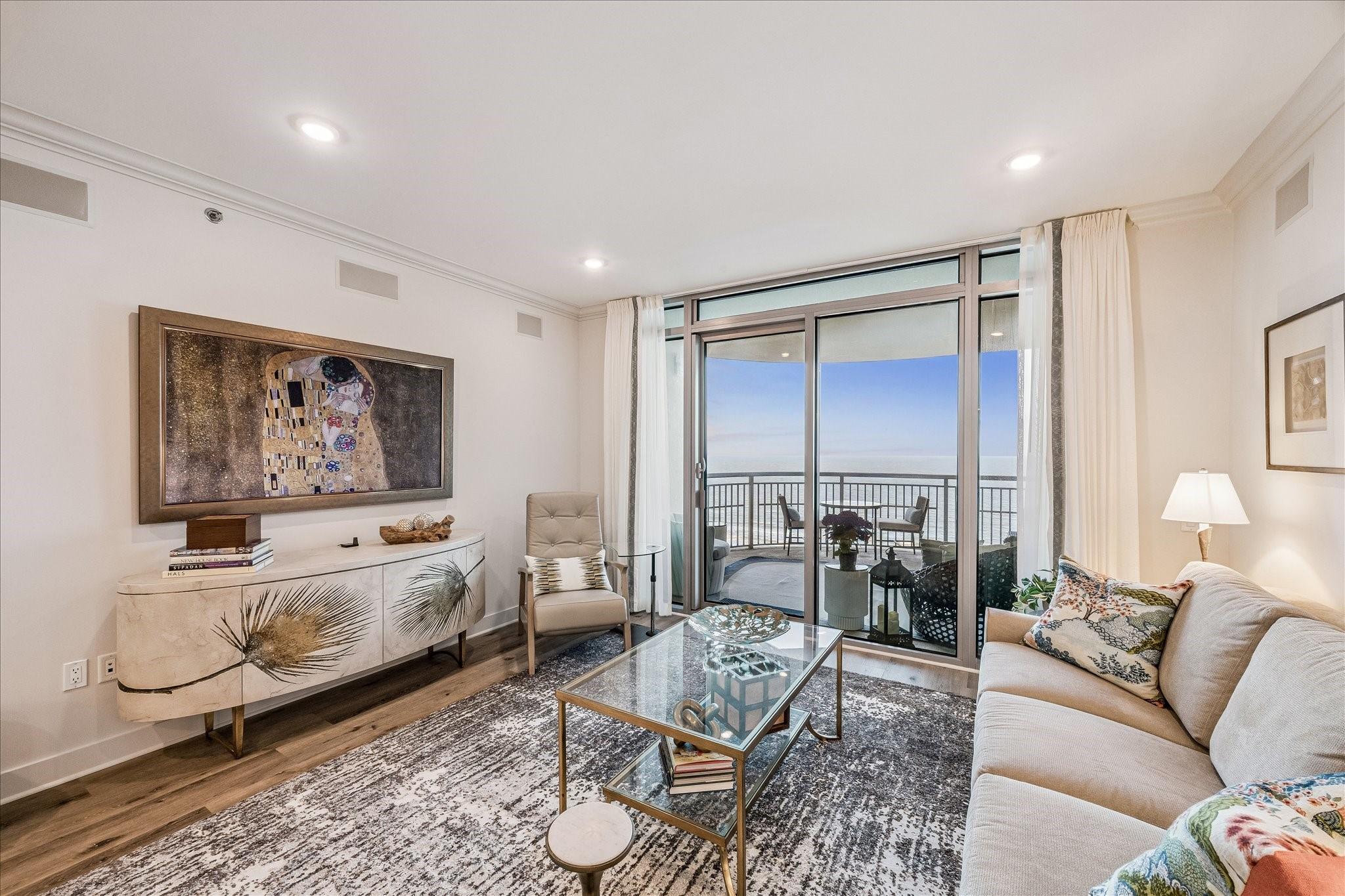 Image 4: This bright living room features floor-to-ceiling
