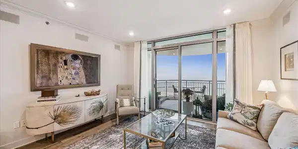 Image 4: This bright living room features floor-to-ceiling