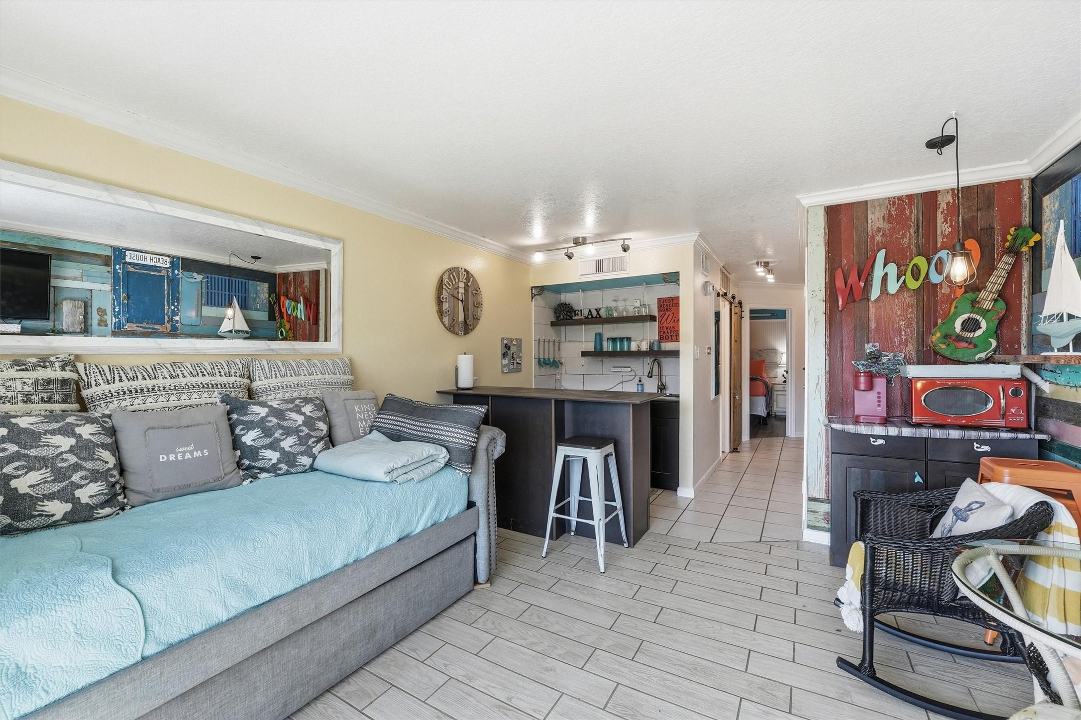 Image 2: This cozy living space features a bright, open lay