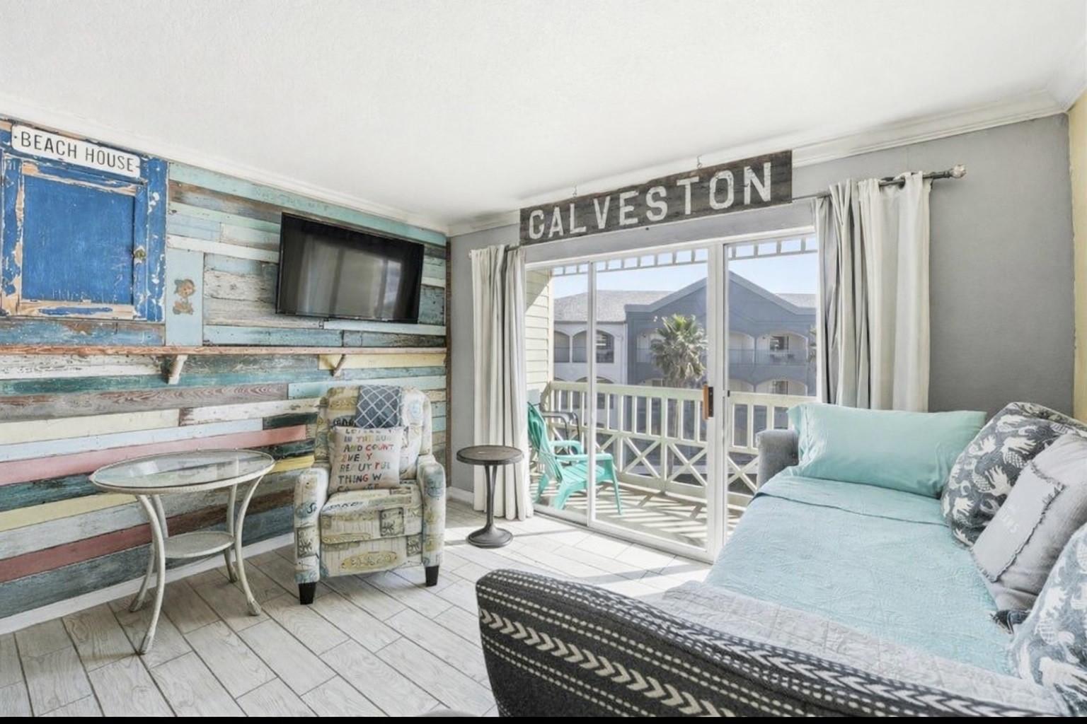 Image 3: Bright, beach-themed room with a cozy, eclectic de