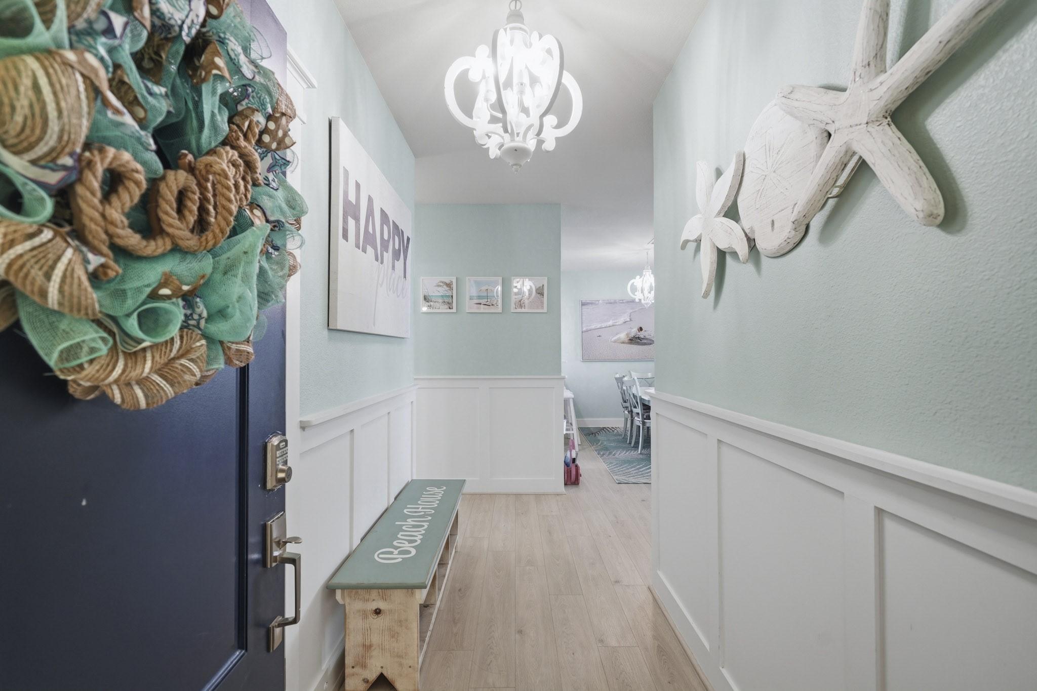 Image 3: A cheerful entry welcomes you inside with coastal
