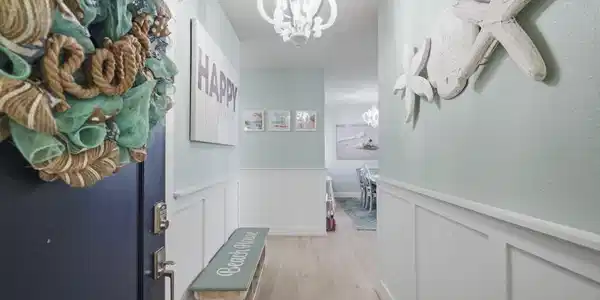 Image 3: A cheerful entry welcomes you inside with coastal