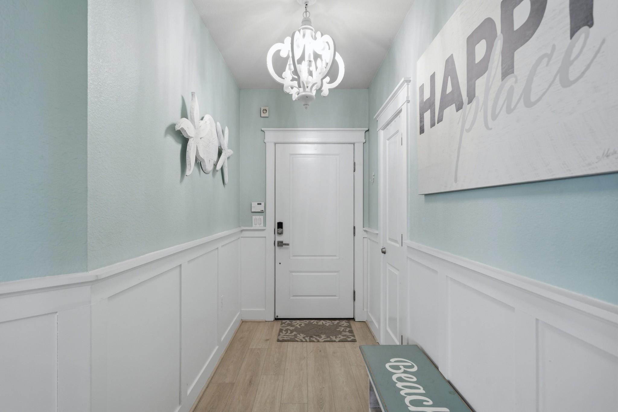 Image 4: The welcoming hallway sets the tone with bright fi
