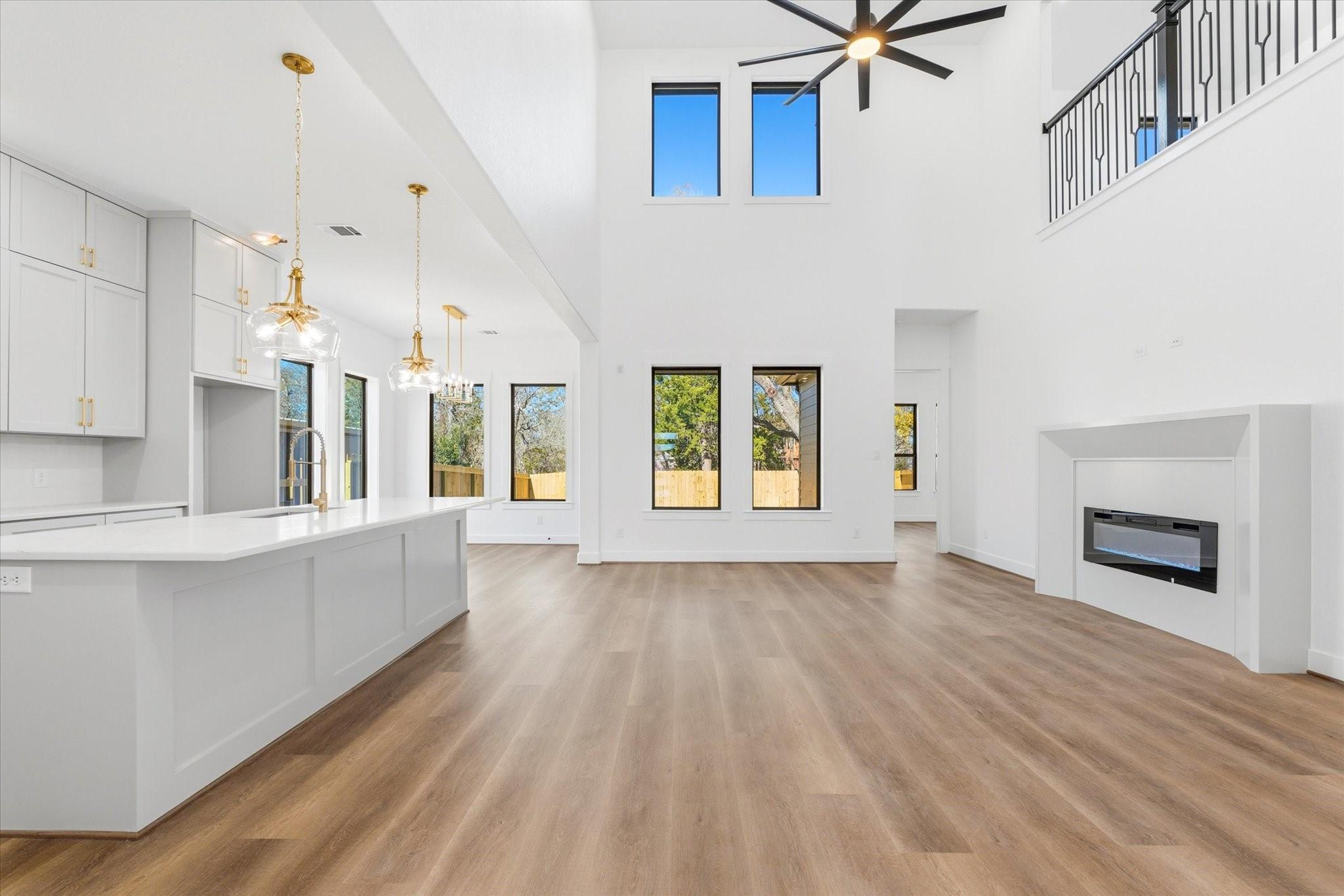 Image 1: Beautiful picture windows surround the open-concep