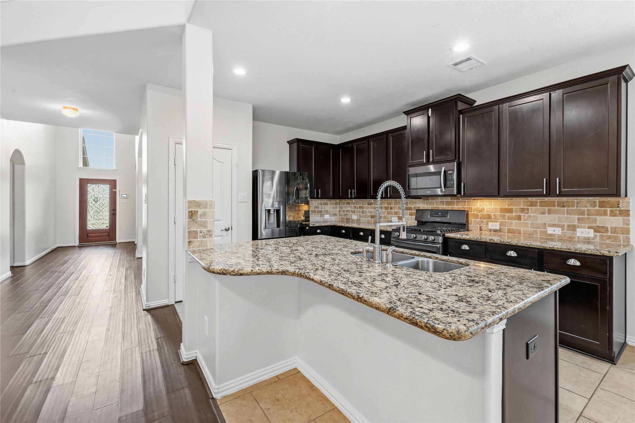 Image 1: Open concept kitchen with generous counter space