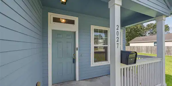 Image 3: A closer look at the covered front porch, offering
