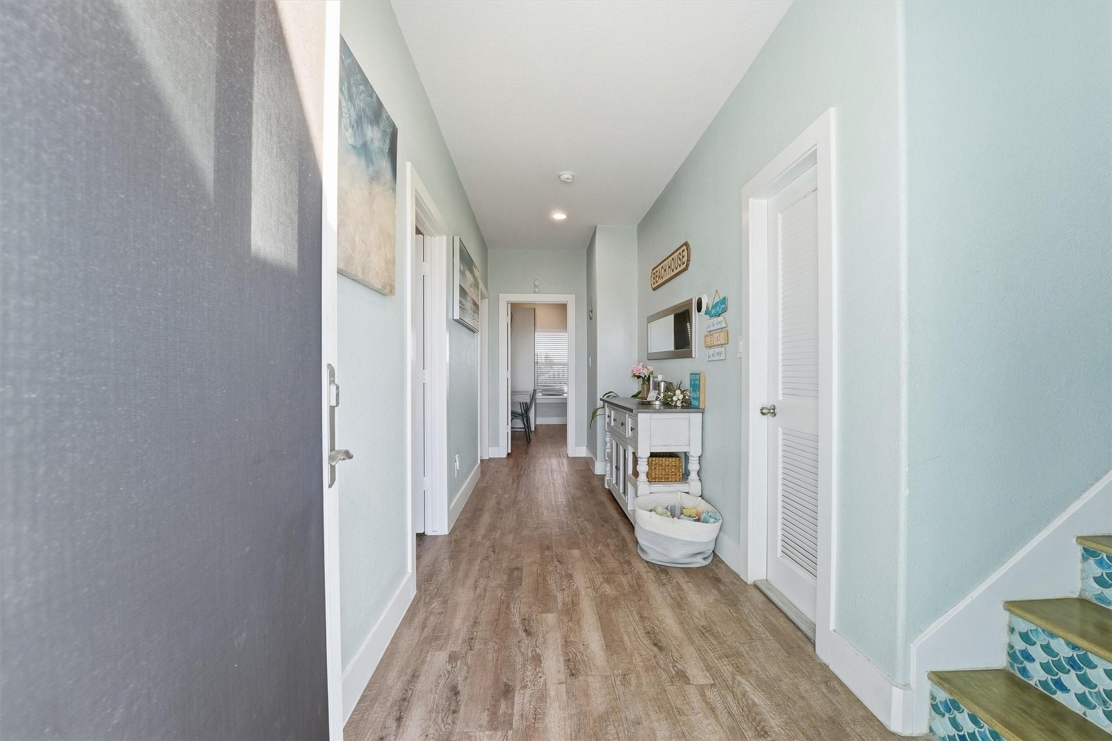 Image 3: Welcoming entry hallway featuring coastal-inspired