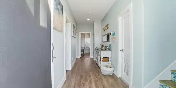 Image 3: Welcoming entry hallway featuring coastal-inspired