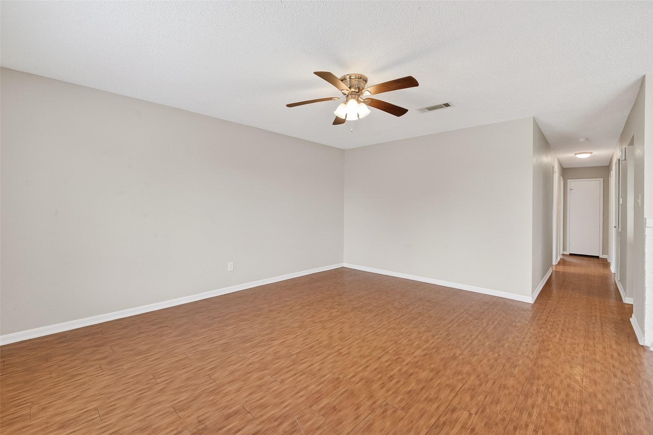 Image 3: Spacious living area with LVP flooring & ceiling f