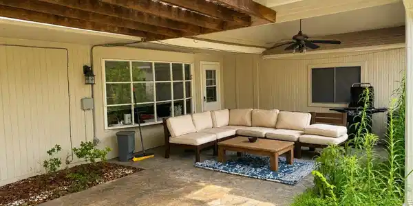Image 2: Charming covered patio featuring a comfortable out