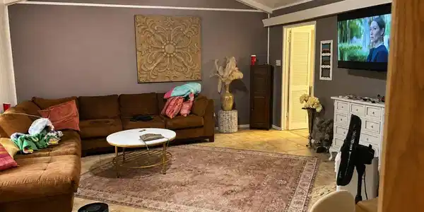 Image 3: Spacious living room featuring a cozy sectional so