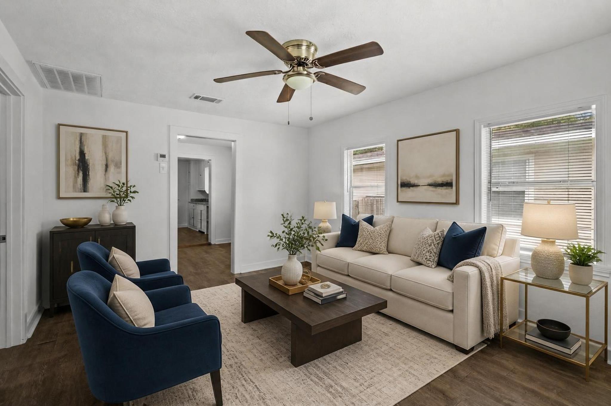 Image 2: The living room opens into a bright, remodeled int