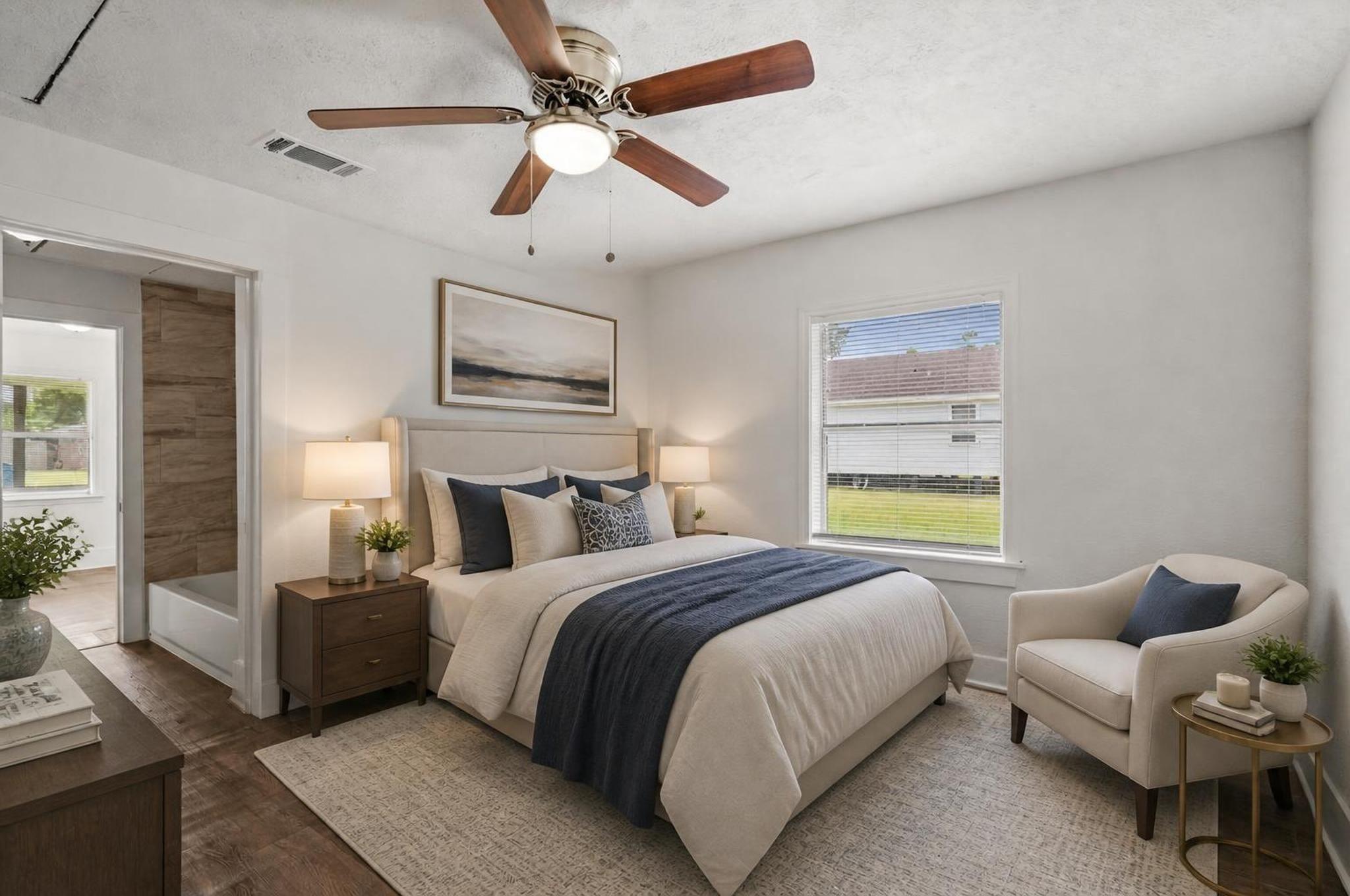 Image 4: The primary bedroom offers a comfortable first-flo