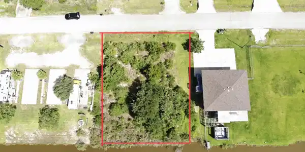 Image 2: Aerial view shows a lot outlined in red, offering