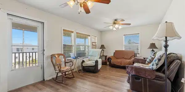 Image 3: Living room with view of front entrance.