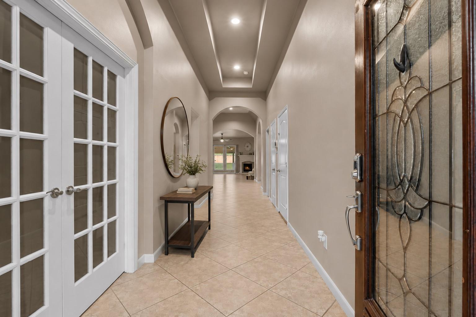 Image 2: Enter through a grand foyer featuring soaring ceil
