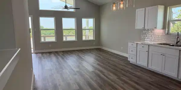 Image 3: Living room has abundant natural lighting   and op
