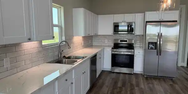 Image 4: Granite countertops and stainless steel appliances