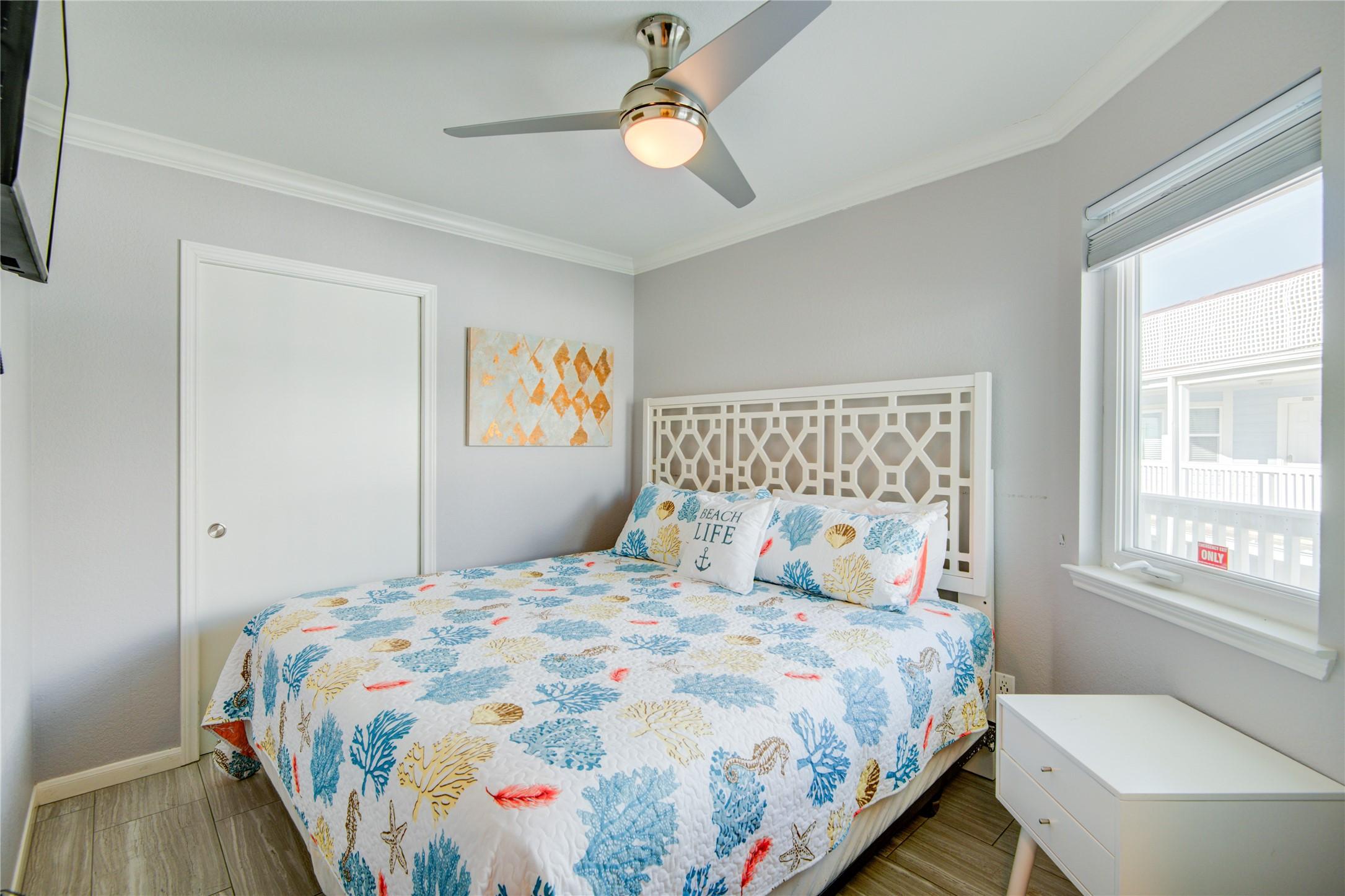 Image 4: Bedroom is bright and inviting, featuring a large