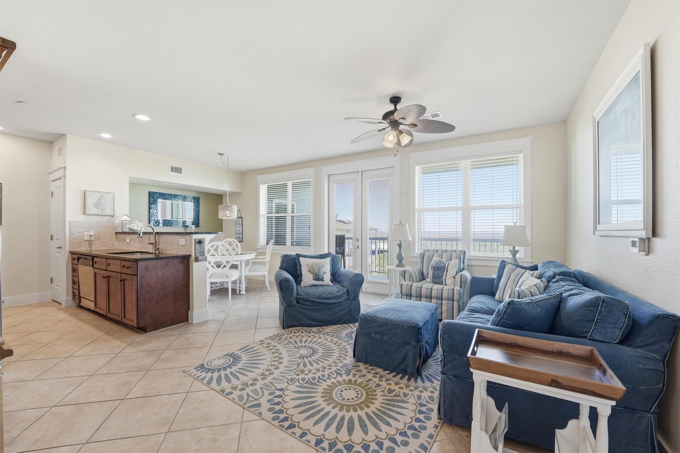 Image 3: The spacious living area features easy-care tile f