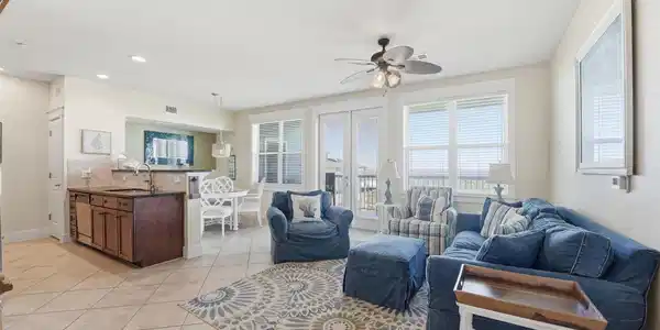 Image 3: The spacious living area features easy-care tile f