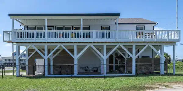 Image 2: Wide covered deck with Beach Views and also a sun