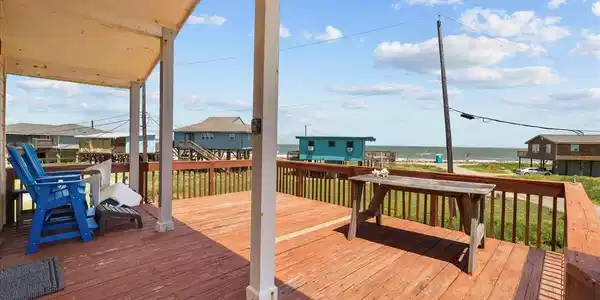 Image 3: This photo showcases a spacious wooden deck with o