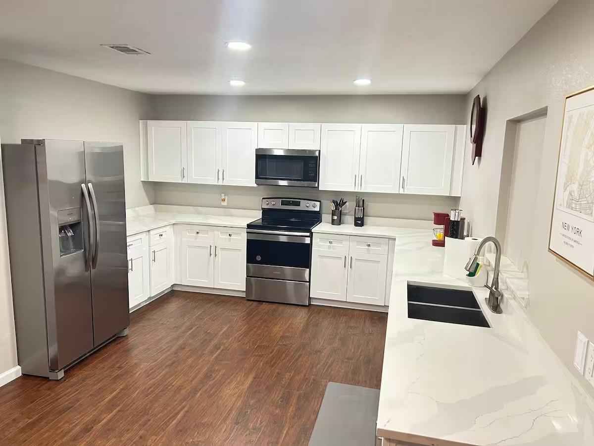 Image 4: Bright open concept layout with durable flooring t