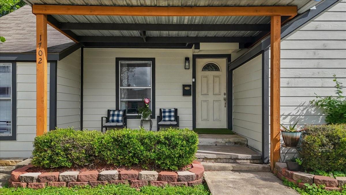 Image 3: Inviting front exterior with a covered porch, warm