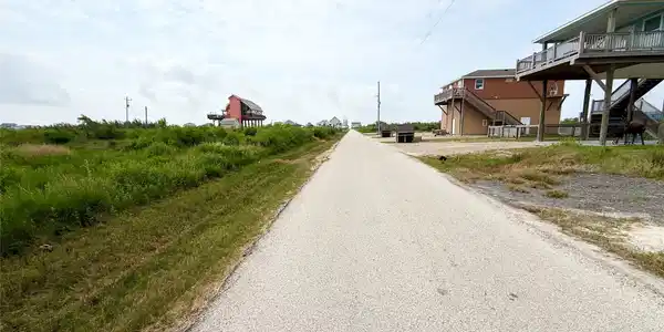 Image 3: Charming elevated homes line a serene coastal road