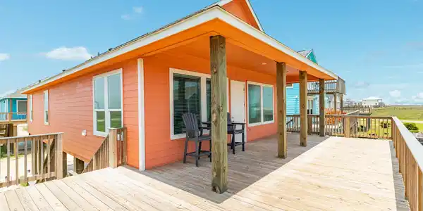 Image 4: This photo showcases a charming beach house with v
