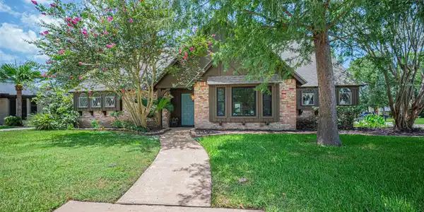 Image 2: Nestled on a corner cul-de-sac lot, this home has