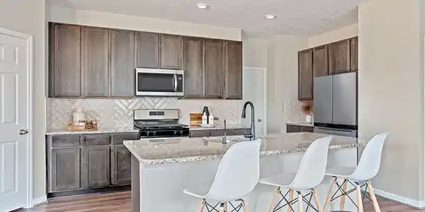 Image 4: Modern open-concept kitchen featuring Woodmont cab