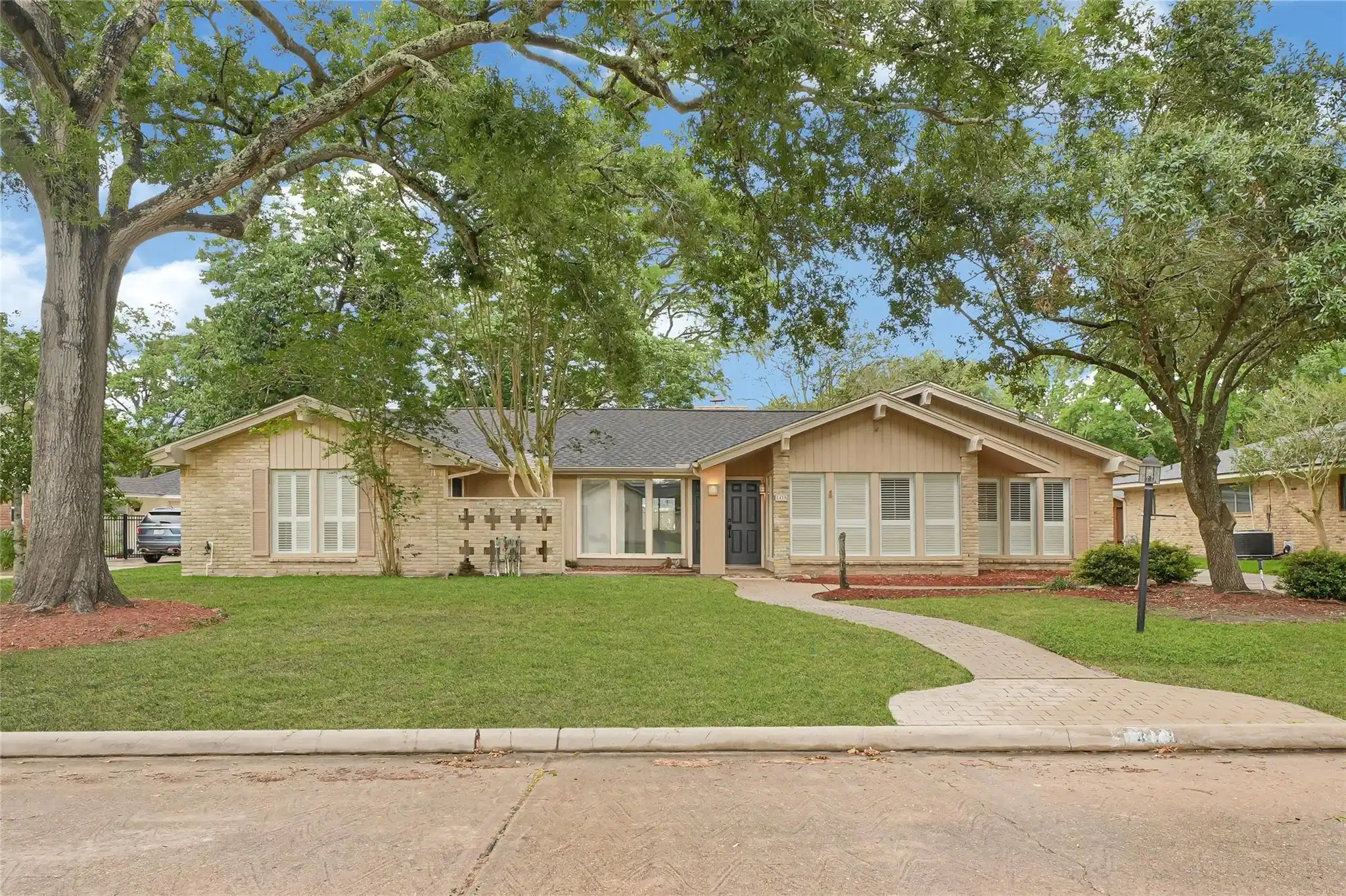 Image 1: Charming single-story home with a brick exterior,