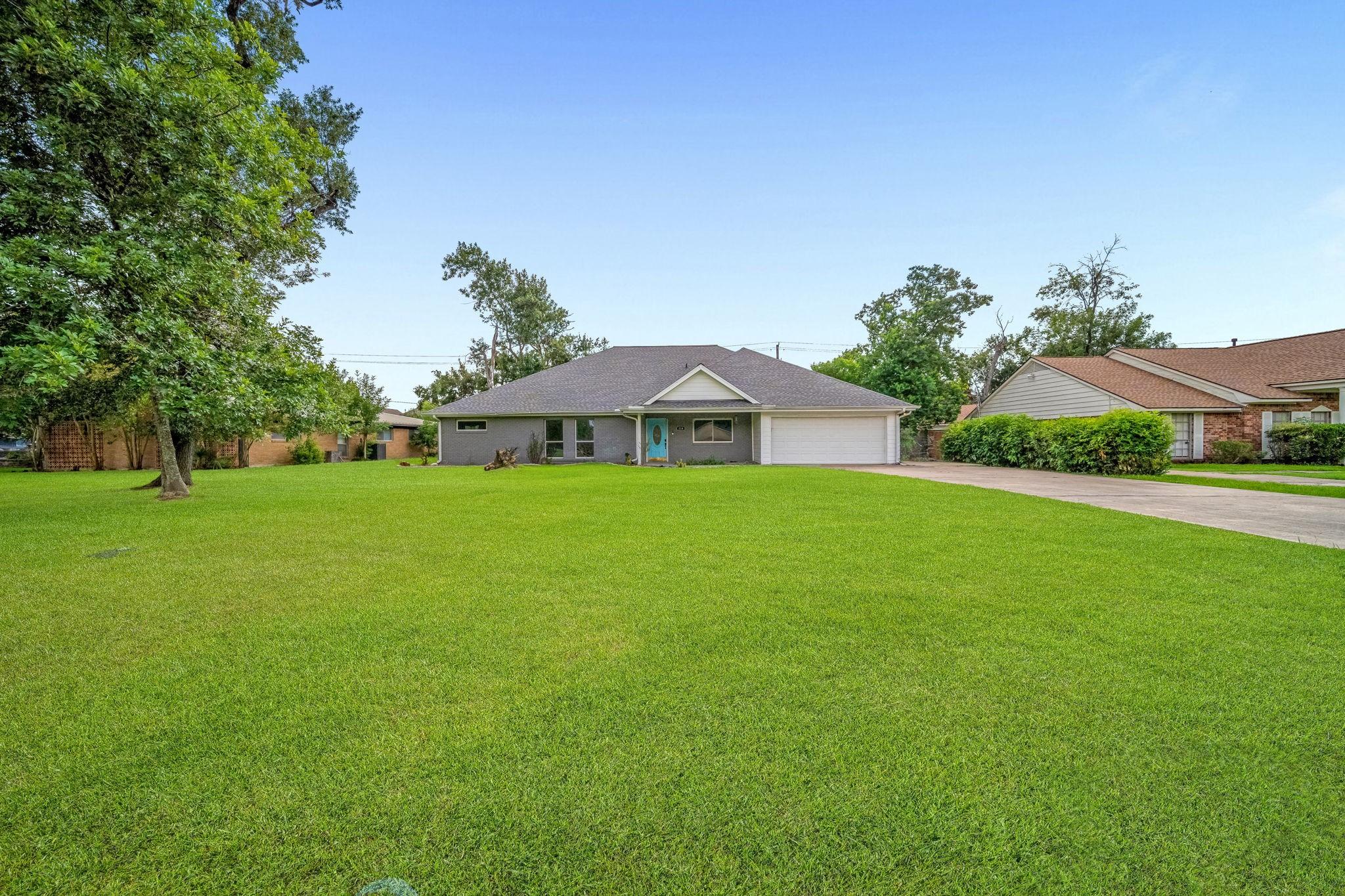 Image 3: A long, private driveway leads to the spacious two
