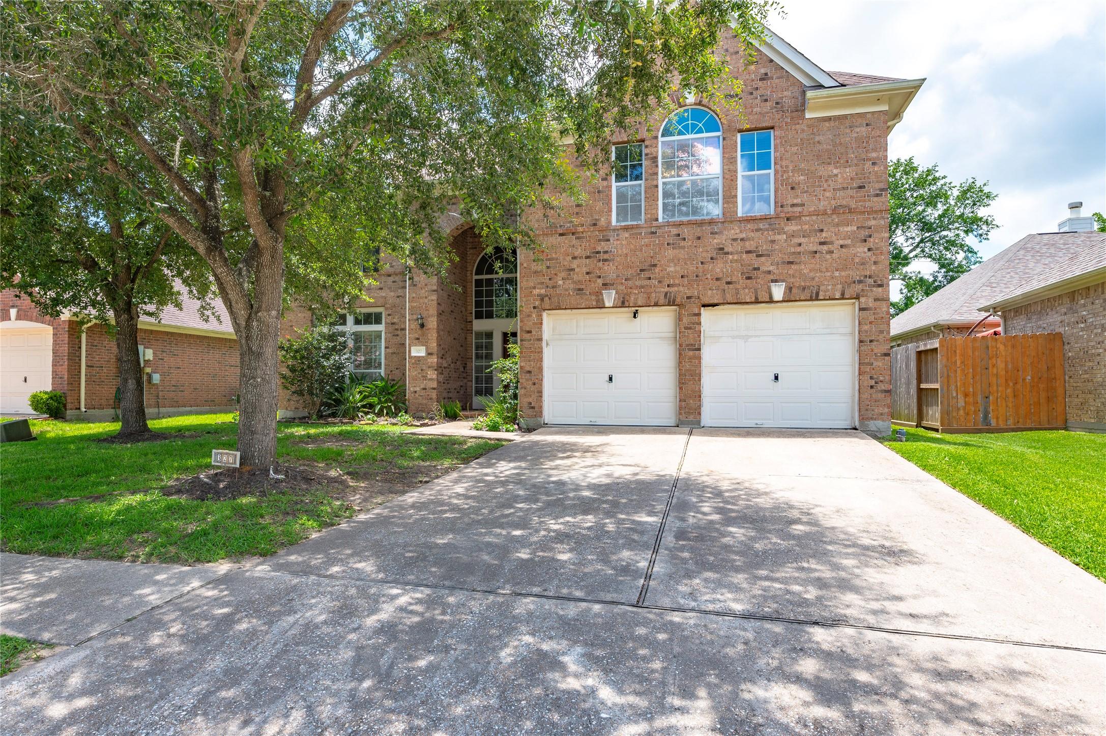 Image 2: Large double wide driveway leads to the 2 car atta