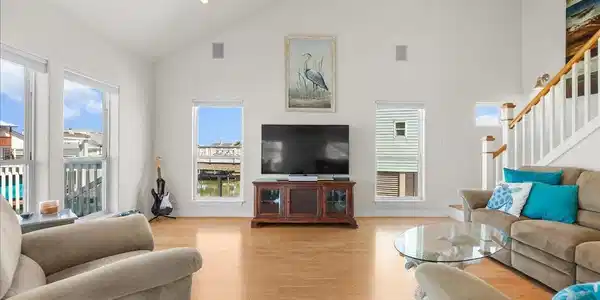Image 3: The spacious living room features soaring ceilings