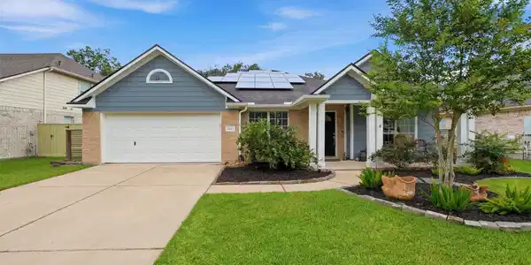 Image 2: Welcoming curb appeal featuring a charming covered